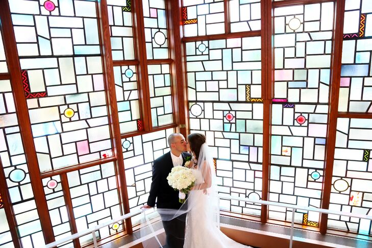 The bride and groom share a private kiss after leaving the sanctuary of the Church of the Messiah United Methodist.