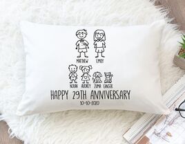Stick person drawings of family and 'Happy 29th Anniversary' at bottom on white throw pillow