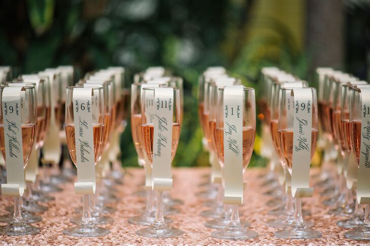 The escort cards were a shaped like tiny scrolls and hung from glasses of pink champagne. “I loved these,” Lona says. “I searched long and hard for a unique and fun escort display that wouldn't break the bank.”