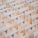 The bunting design that Katie and Garret used on their DIY invitations was echoed on their escort cards.