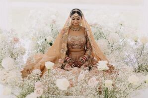 Sikh Bride Sitting Amongst Flowers at Guru Granth Sahib Altar at Religious Ceremony