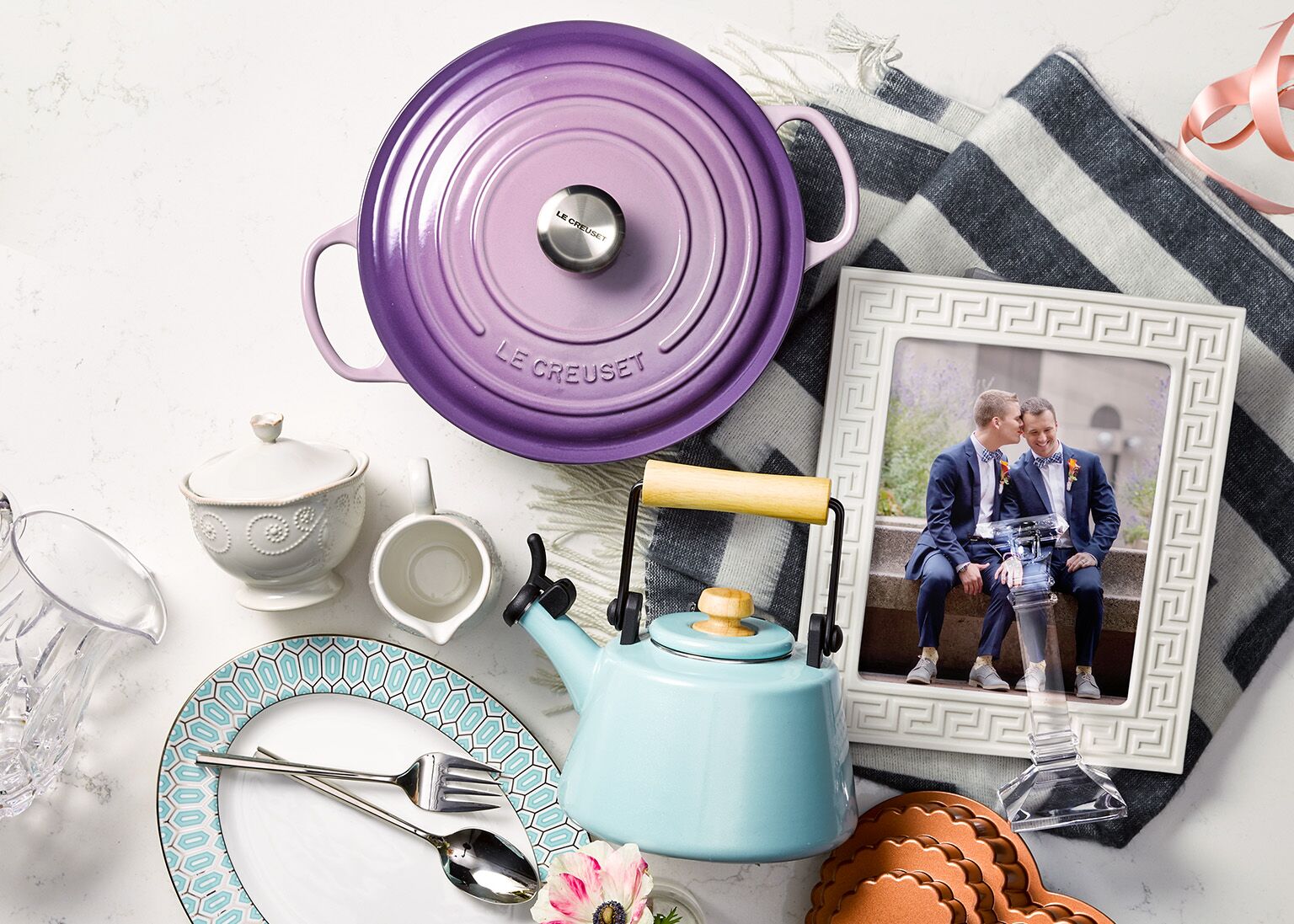 Wedding gifts laid out on table with picture of couple