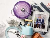 Wedding gifts laid out on table with picture of couple
