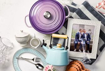 Wedding gifts laid out on table with picture of couple
