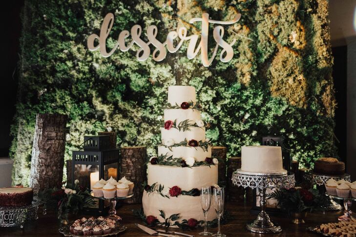 Elegant Dessert Table with Tiered Cake and Moss Backdrop
