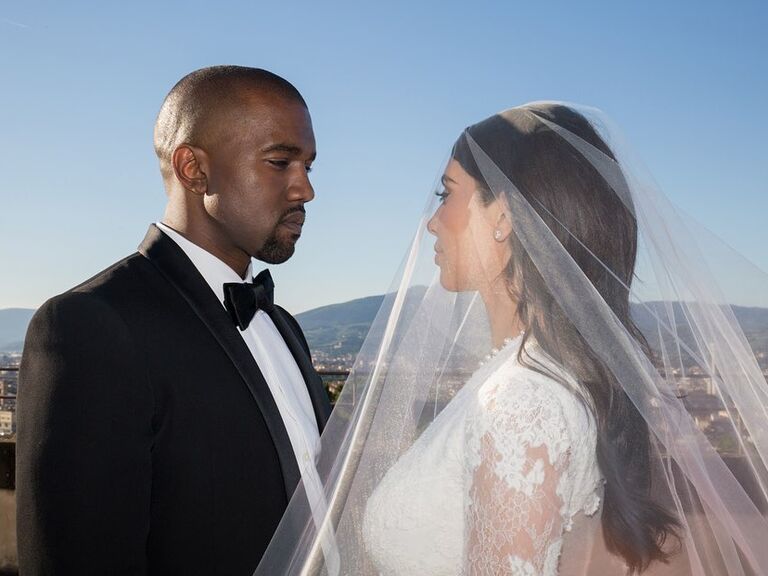 Kim Kardashian and Kanye West posing for a picture on their wedding day