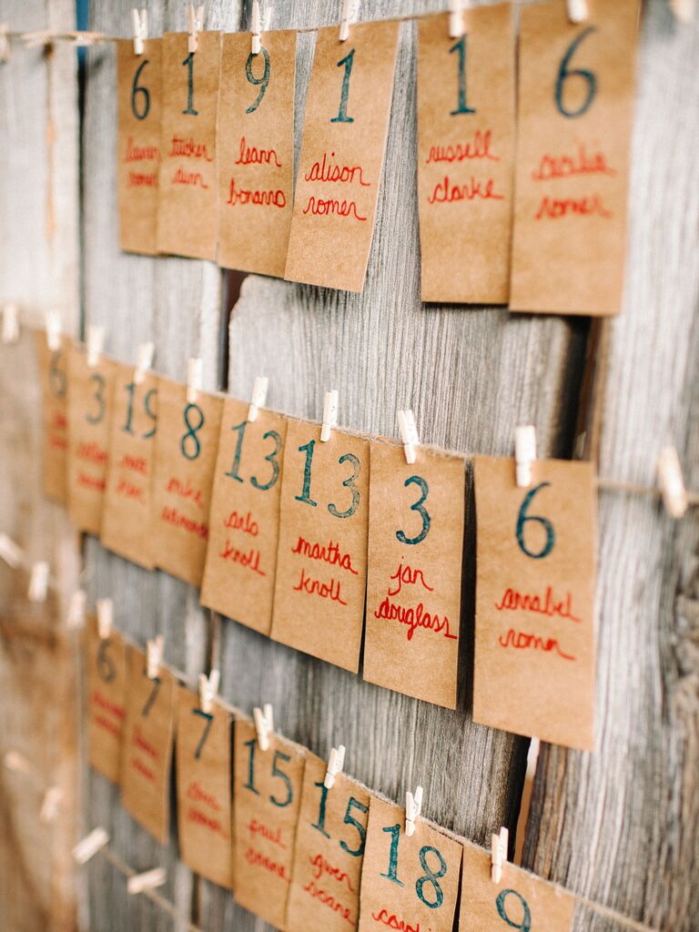 rustic wedding escort card display with clothespins and twine