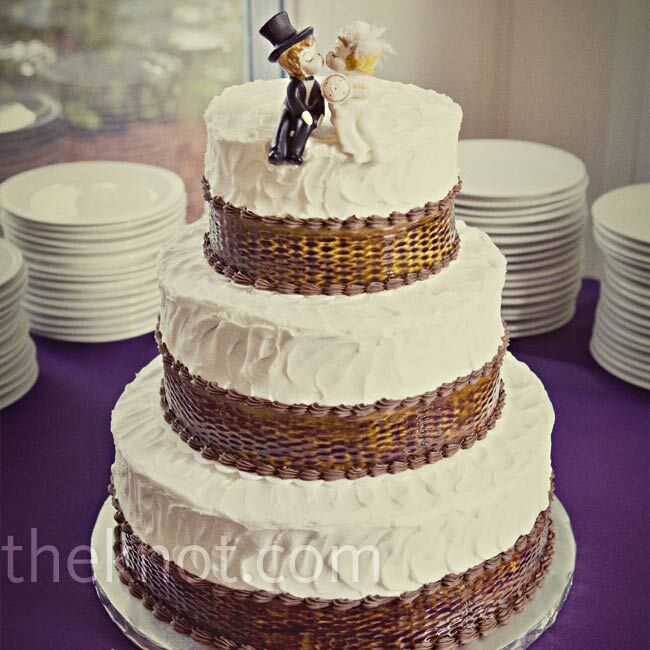 Jen called on her Eventcetera team once again, and a family friend made the three-tiered cake. She used a special tool to press a woven basket pattern into the white icing and painted on brown coloring. Jen and Jeff found vintage cake toppers at their favorite antique shop.