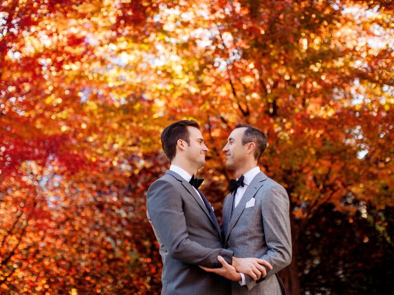 Two men gaze into each other's eyes for their autumn engagement photoshoot