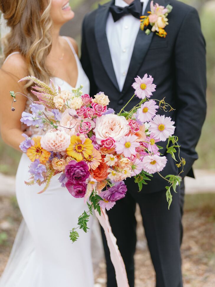 Bride Holding Large Bright and Pastel Bouquet of Purple, Pink, Yellow, Orange, Yellow and Lavender