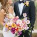 Bride Holding Large Bright and Pastel Bouquet of Purple, Pink, Yellow, Orange, Yellow and Lavender