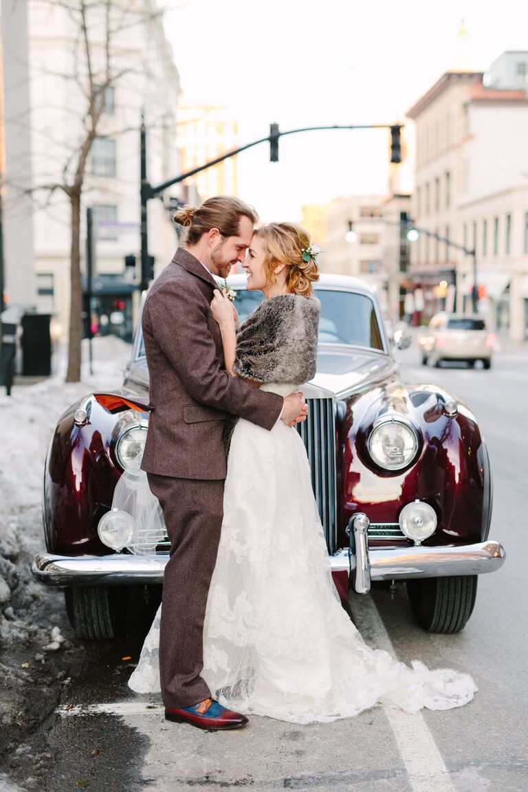 bride and groom in front of vintage car
