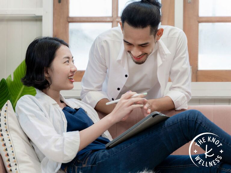 Couple smiling together while journaling