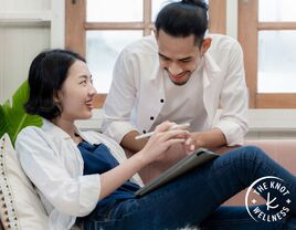 Couple smiling together while journaling