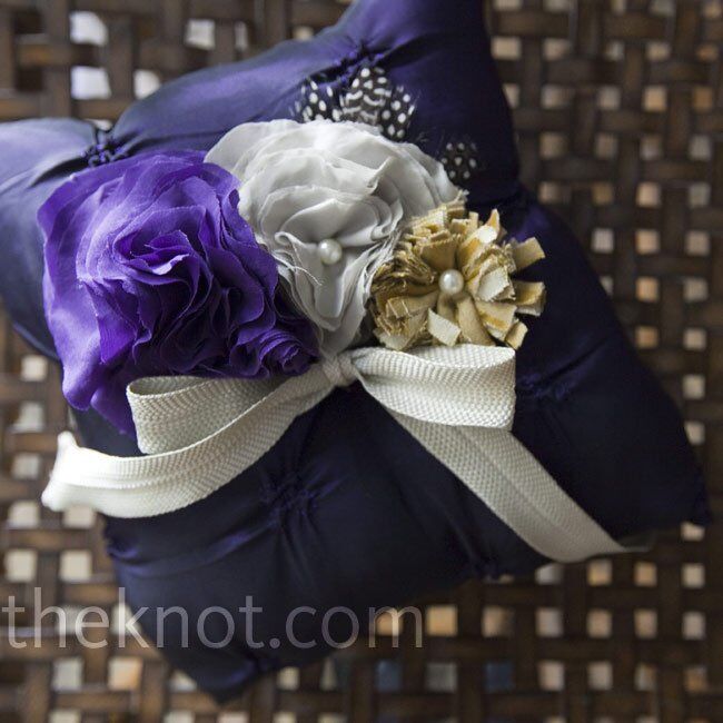 Gray and purple silk blooms and feathers decorated this handmade ring pillow.