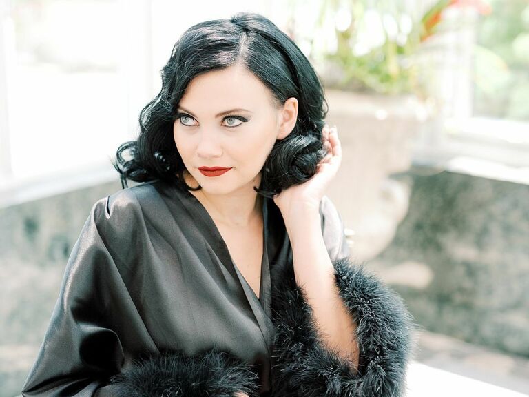 Bride wears a glamorous silk bathrobe and her hair in timeless Hollywood curls. 