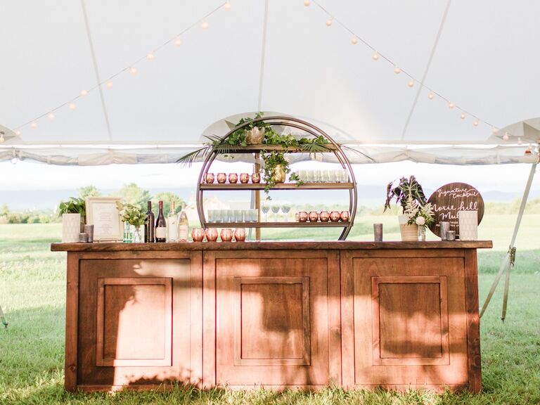 Wooden bar service with copper accoutrement at wedding reception space