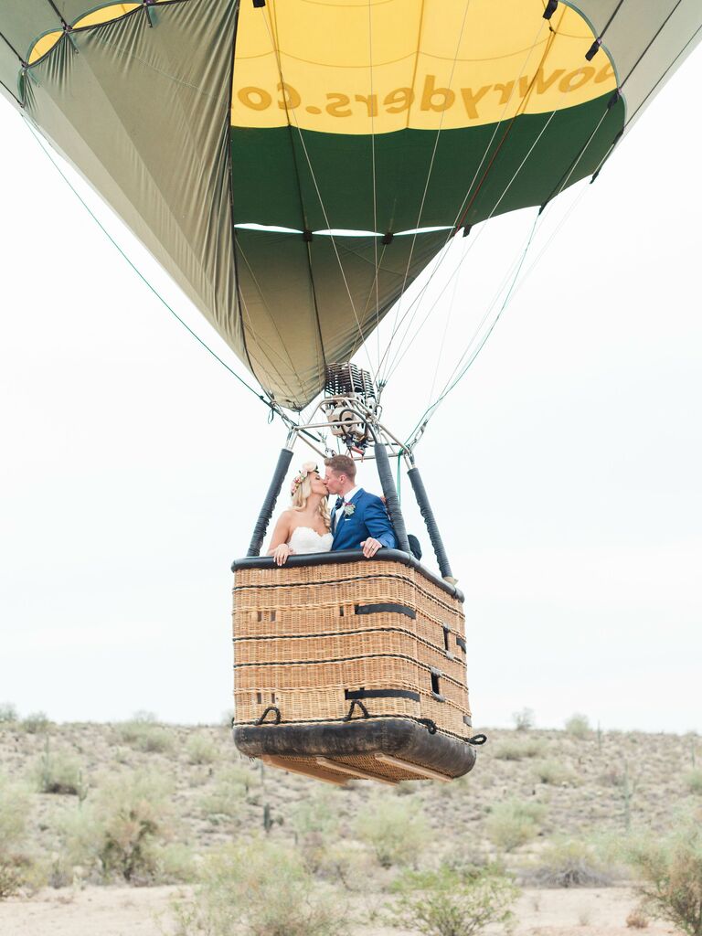 Couple arriving to the reception in a hot air balloon.