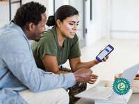 Couple using budgeting app to track finances together