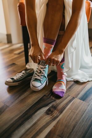 Bride Wearing Blue Converse Underneath Her Wedding Dress