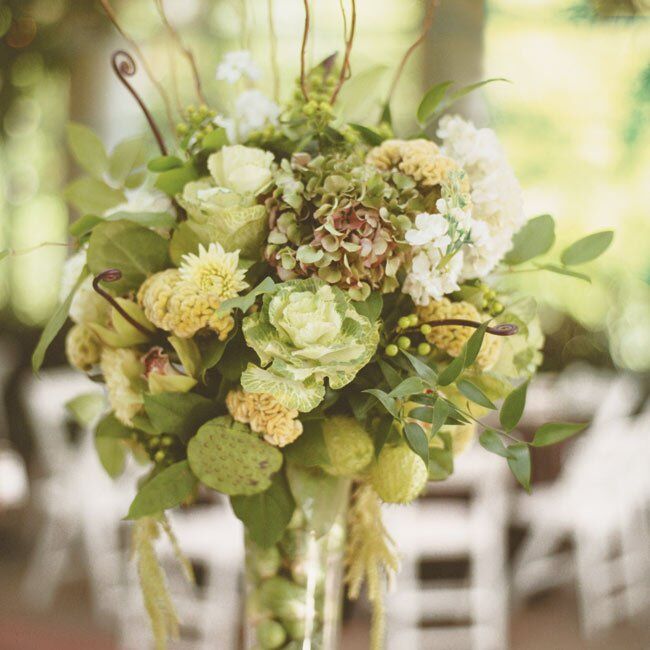 Some tables had tall arrangements of glass vases filled with Brussels sprouts and cabbage leaves that were topped off by lush blooms, including hydrangeas, orchids, dahlias, ferns, and pods. Other tables featured long, low centerpieces of orchids, bells of Ireland, celosia, dahlias, and artichokes.