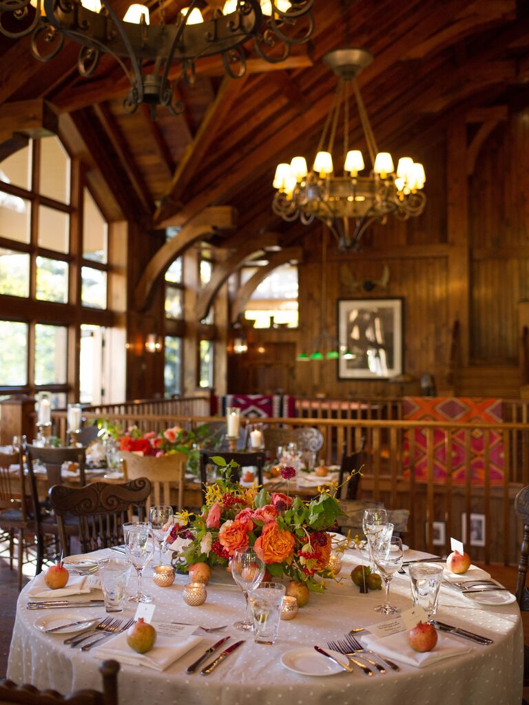 cabin wedding reception venue with orange and pink centerpieces