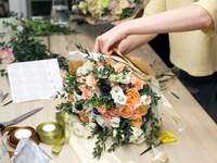 Woman making beautiful floral arrangement online flower gift delivery service