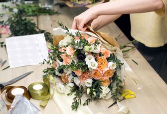 Woman making beautiful floral arrangement online flower gift delivery service