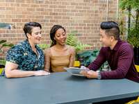 A couple go over logistics with their wedding planner before the big day.