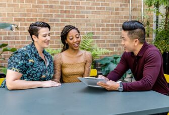 A couple go over logistics with their wedding planner before the big day.