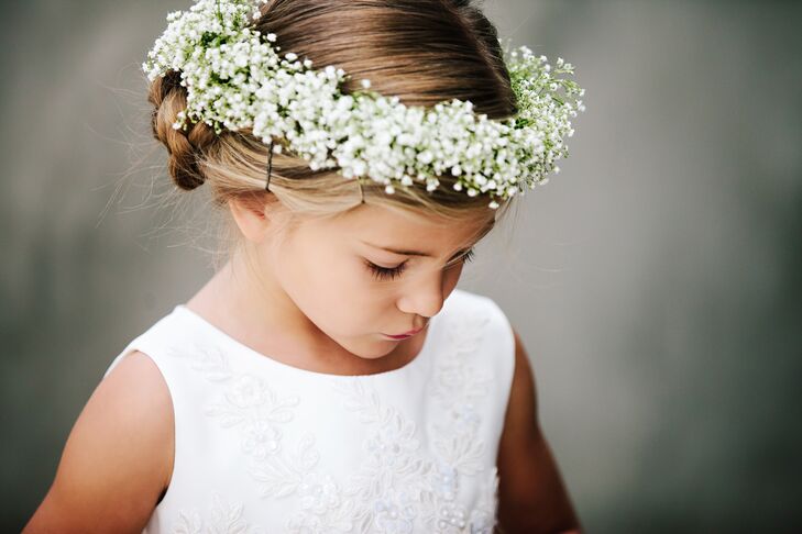 The flower girls wore baby's breath flower crowns tied with a white ribbon in the back, adding a romantic feel to the classic style of the wedding theme.