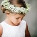 The flower girls wore baby's breath flower crowns tied with a white ribbon in the back, adding a romantic feel to the classic style of the wedding theme.