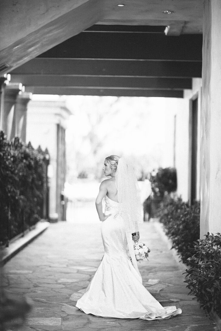 Karlie wore an ivory silk Lazaro mermaid dress with a sweetheart neckline. Floral embroidery covered the bodice, and a silk sash with a flower around the waist brought the whole look together.