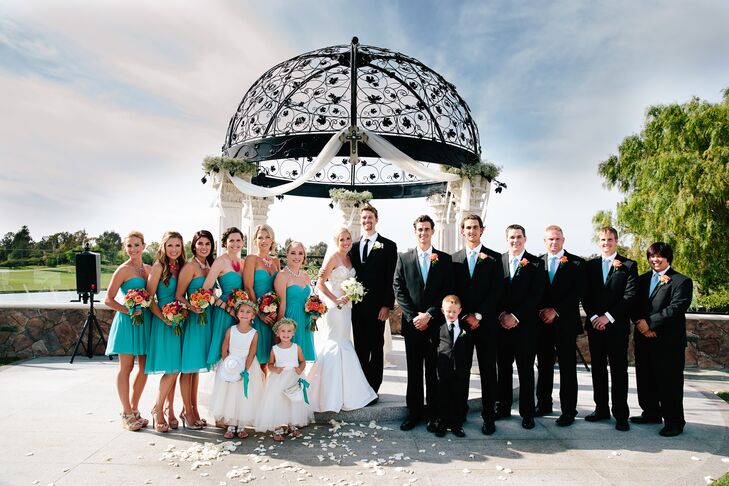The bridesmaids wore teal strapless chiffon Donna Morgan dresses, while the groomsmen wore black suits with white button-ups and teal ties.
