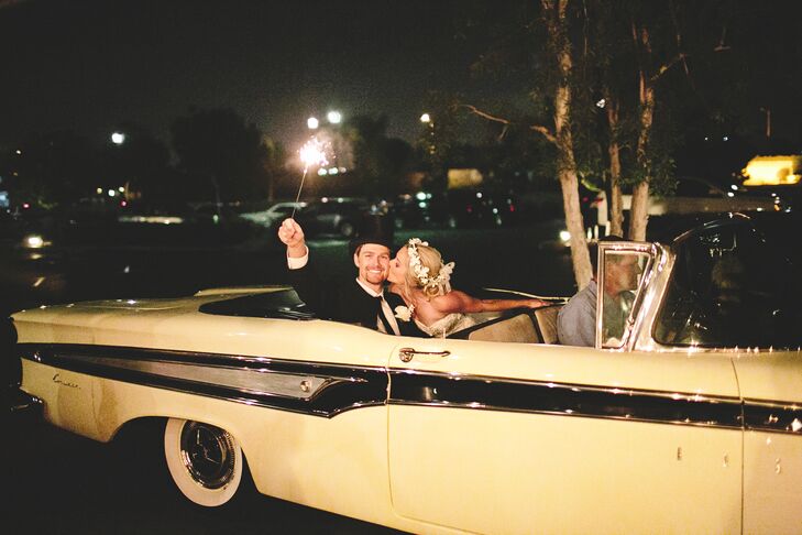 Guests sent off the couple with a sparkler exit, and the couple left their wedding in style in a vintage white Oldsmobile.