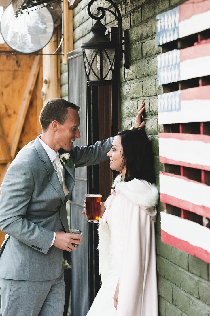 Sarah and Kolton leaned against the wood wall of their reception venue, the Nickel Beer Company in Justin, California.