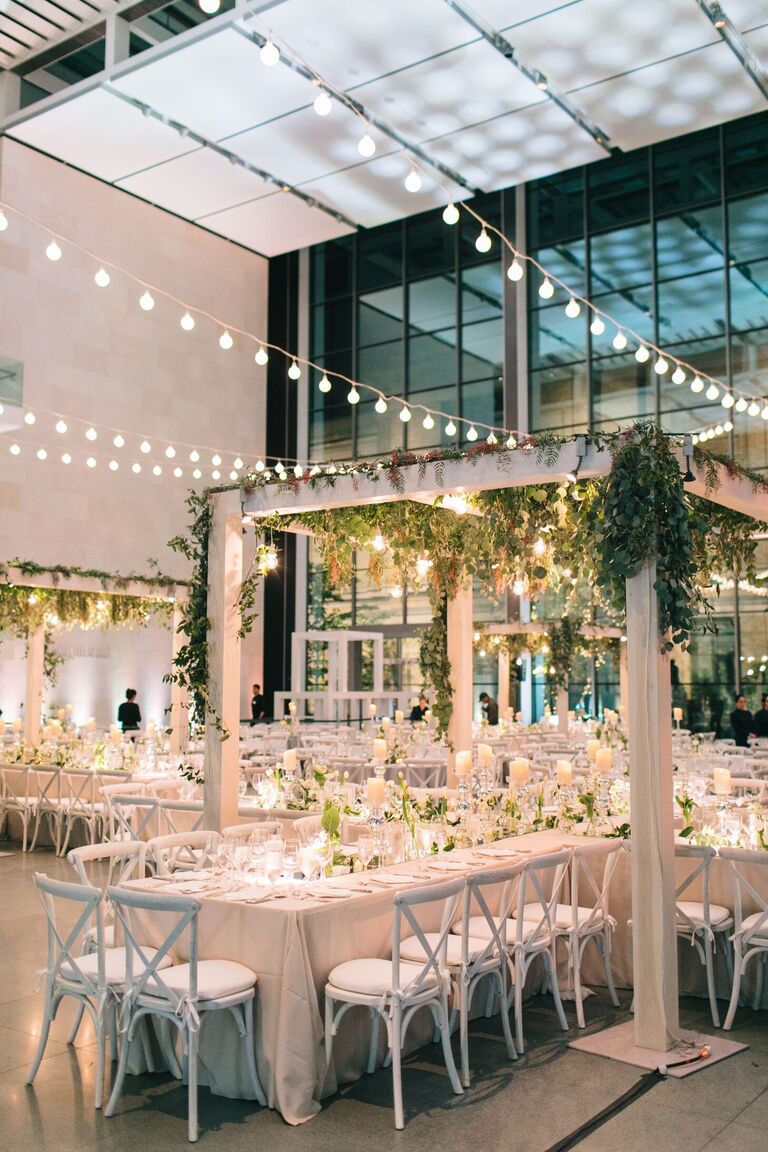 Indoor wedding reception with pergola and string lights
