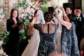 Mothers of the Bride and Groom Performing Cord Ceremony Over Couple