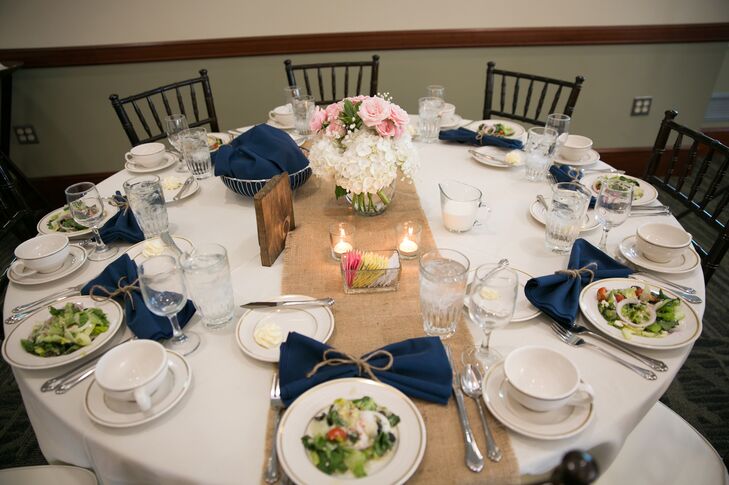 “The table linens were ivory with burlap table runners. Each table had a floral centerpiece along with votive candles, floating candle with branches in the vase and wooden table numbers,” says the couple.