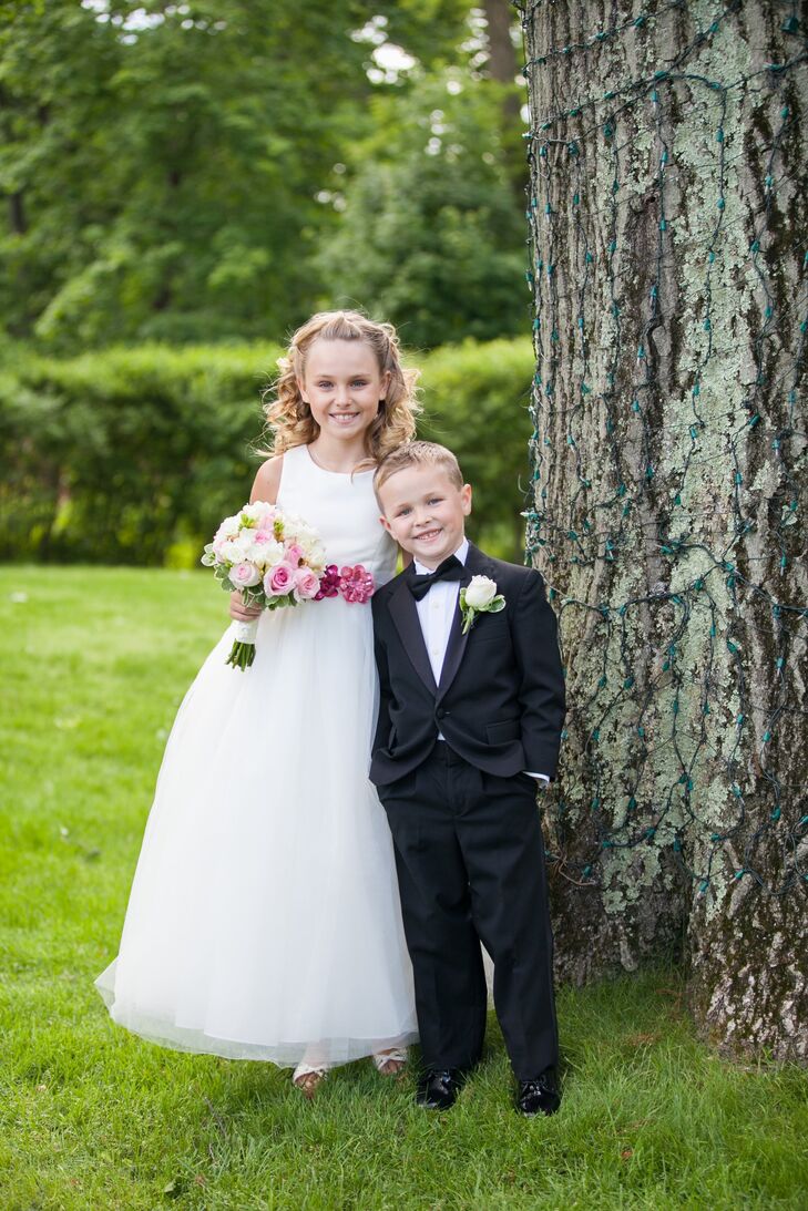The flower girl looked adorable in a long white a-line dress with a pink floral belt and a smaller bouquet to match the bride's. The ring bearer matched the groomsmen in a black tuxedo with a black bow-tie.