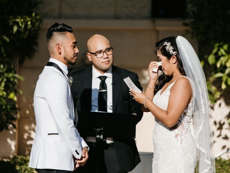 bride crying during wedding vows at wedding ceremony