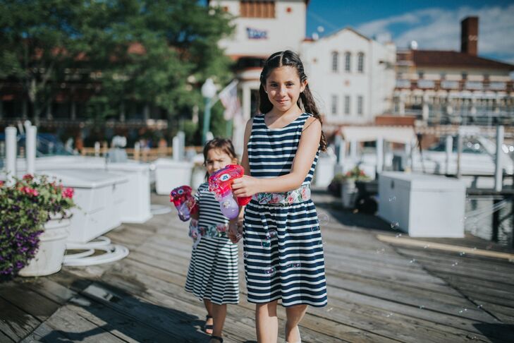 The flower girls wore navy-and-white-striped dresses and walked down the dock (aisle) to Elvis Presley's “Can't Help Falling in Love.”